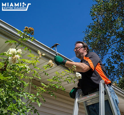 Technician Repairing a Rain Gutter