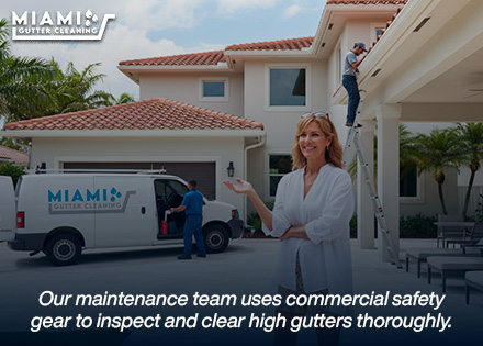 A homeowner standing safely on their patio, smiling while a professional service vehicle completes an automated gutter maintenance visit.