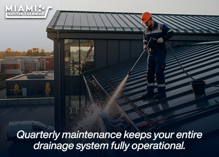 A technician from our maintenance division thoroughly flushing a gutter channel during a scheduled quarterly visit.