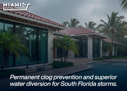 A wide shot of a Miami home during a heavy downpour, showing clean water discharging smoothly from downspouts with zero overflow.