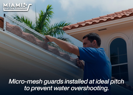 A technician from our maintenance division securing an aluminum micro-mesh frame precisely aligned with a roofline.